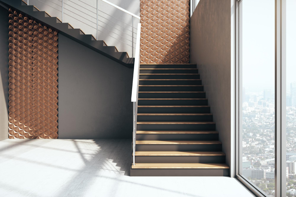 Desain tangga minimalis modern pada rumah 2 lantai dengan railing sederhana sebagai elemen estetika interior.